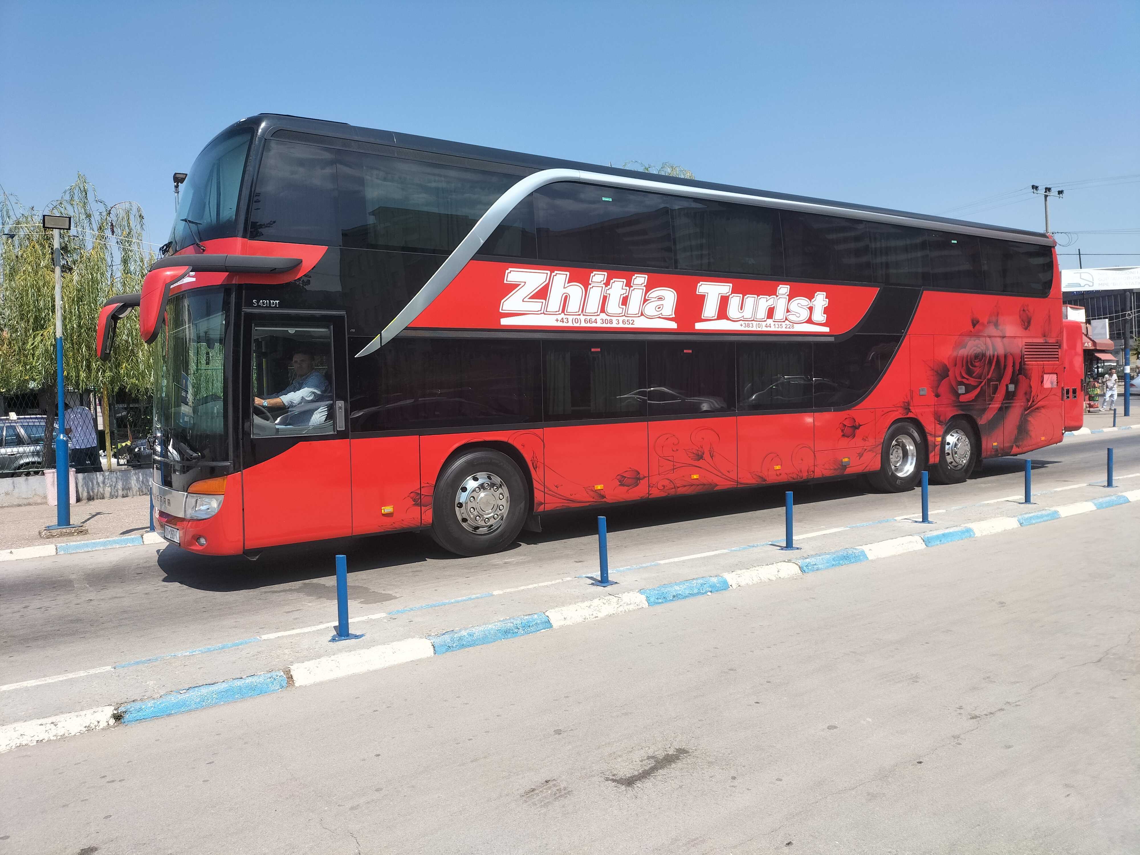 Red Zhitia Turist Bus white an image of an Rose on it